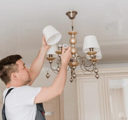 Heavy crystal chandelier installation and hanging service in Dubai villa.